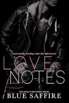 A book cover for "Love Notes: The Moran Brothers Series" by Blue Saffire. The cover features a close-up shot of a person's torso and upper body. The person is wearing a black leather jacket over a gray hooded sweatshirt and a light-colored shirt. The person's face is partially obscured, showing only their jawline and chin. The title, "LOVE NOTES," is written in large, stylized white letters in the center of the cover. Below the title, it reads "THE MORAN BROTHERS SERIES" in smaller white letters. The author's name, "BLUE SAFFIRE," is at the bottom in larger white letters. At the top of the cover, in smaller white letters, it reads "Award-winning, Bestselling, Author Blue Saffire presents." The overall tone of the cover is dark, edgy, and romantic. There are also some faint blue and pink paint-like streaks visible on the cover.
