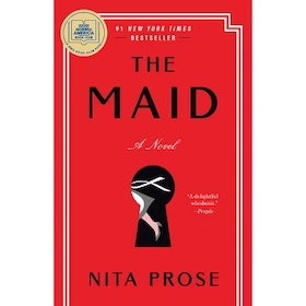 A book cover for "The Maid" by Nita Prose. The cover is primarily a solid red color with a thin, double-lined white border framing the edge. The title, "THE MAID," is written in large, bold, black letters in the center, with "A Novel" in smaller black letters below. In the lower center, there's a black keyhole graphic with a stylized illustration of a woman's leg in a white dress inside. At the top right, a gold circle with the text "#1 NEW YORK TIMES BESTSELLER" is visible. The author's name, "NITA PROSE," is at the bottom in white letters. A small quote is partially visible on the right side of the cover. The overall design is minimalist and striking.