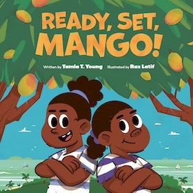 The cover of the children's book "Ready, Set, Mango!" by Tamla T. Young and illustrated by Raz Latif. The illustration features two cartoon children with brown skin, standing with their arms crossed under a mango tree. The child on the left has their brown hair in two puffy ponytails with blue scrunchies and is smiling with one tooth showing. They are wearing a white shirt with blue and white striped sleeves. The child on the right has their brown hair in a single puffy ponytail with a blue scrunchie and is smiling. They are wearing a white shirt with purple and white striped sleeves. Above them, the title "READY, SET, MANGO!" is written in large, playful orange and yellow letters against a green background that suggests leaves. Below the title, in smaller green text, it reads "Written by Tamla T. Young" and "Illustrated by Raz Latif." The background shows a light blue sky, a body of water with small sailboats, and green land with palm trees. The overall style is bright, cheerful, and aimed at young readers.