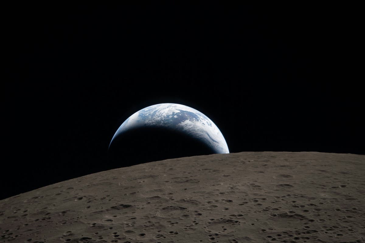 A view of Earth from the moon, with a large shadow cast over Earth from the moon.